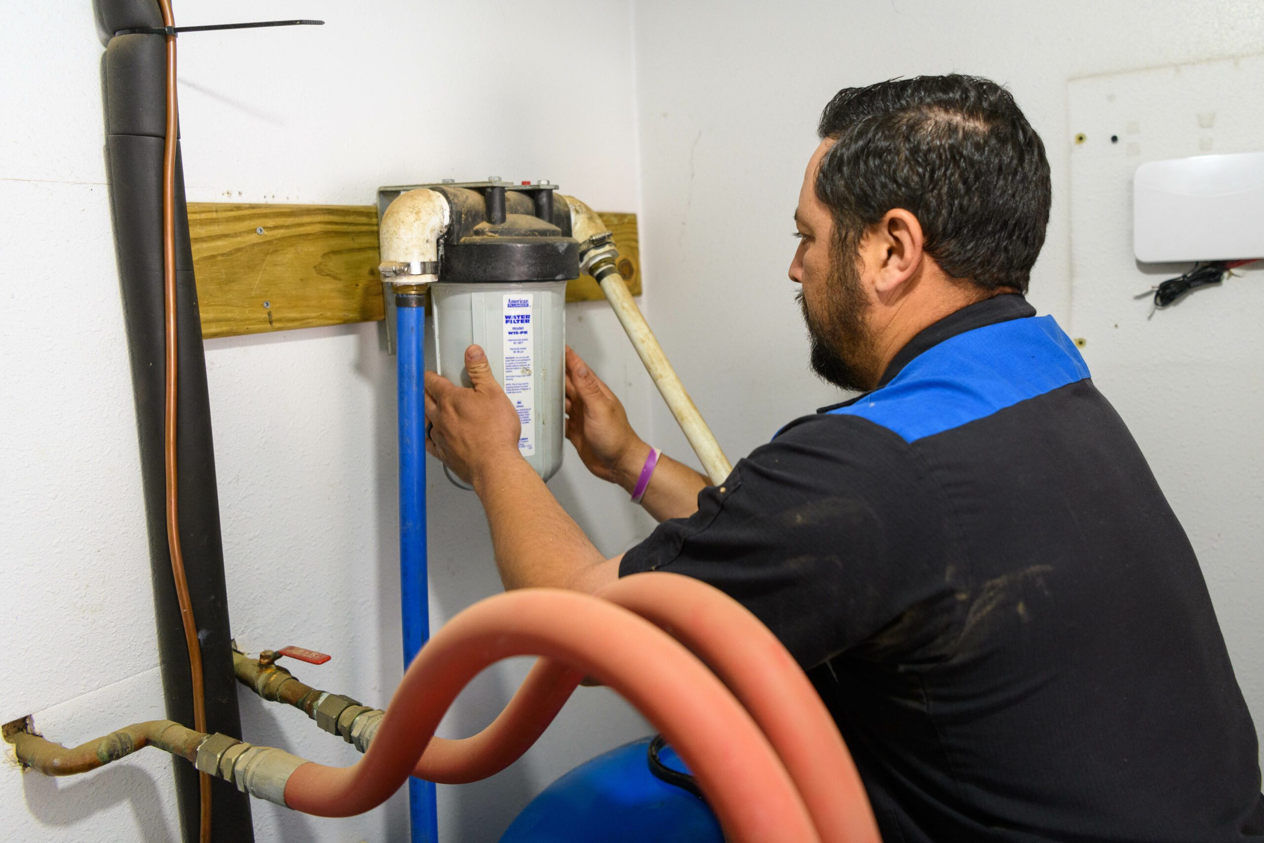 Plumber working with filter